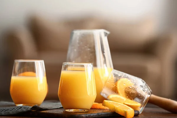 Glasses of tasty orange juice on table — Stock Photo, Image