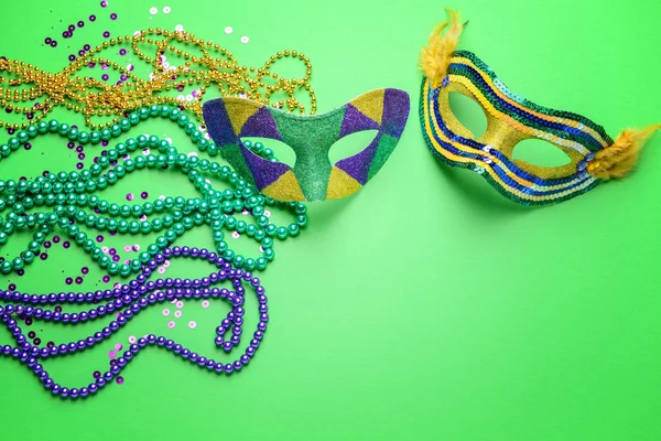 Festive masks with decor on color background — Stock Photo, Image