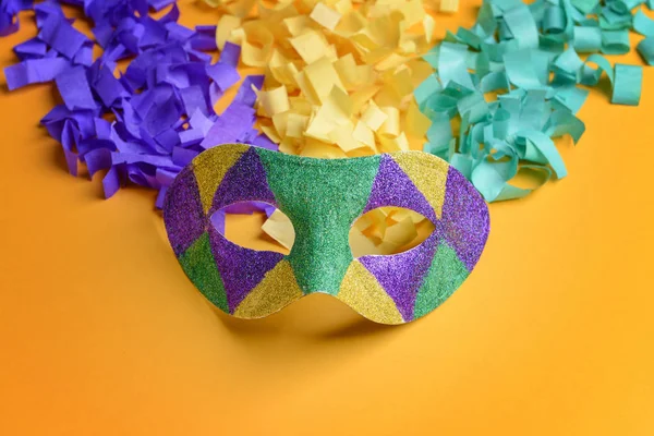 Festive mask with confetti on color background — Stock Photo, Image