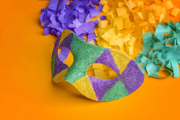 Festive mask with confetti on color background — Stock Photo, Image