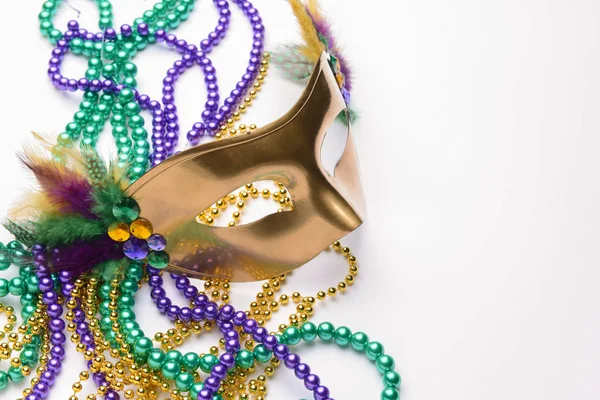 Festive mask with beads on light background — Stock Photo, Image