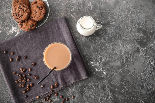 Glass of tasty frappe coffee with milk and cookies on grey table — Stock Photo, Image