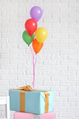 Beyaz tuğla duvar yakın hava balonlar ile güzel hediyeler