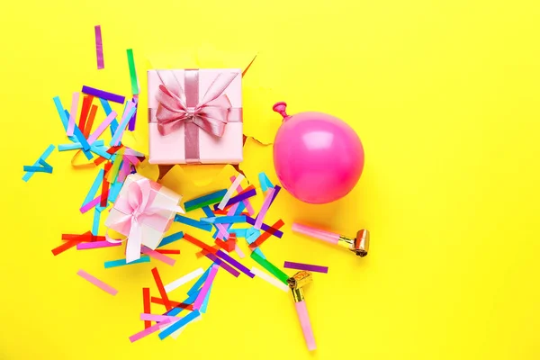 Beautiful gifts with party decor on color background — Stock Photo, Image