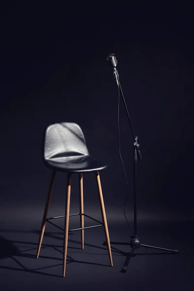 Microphone with chair on dark background