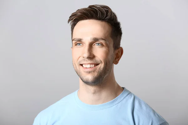 Portrait of handsome man on grey background — Stock Photo, Image