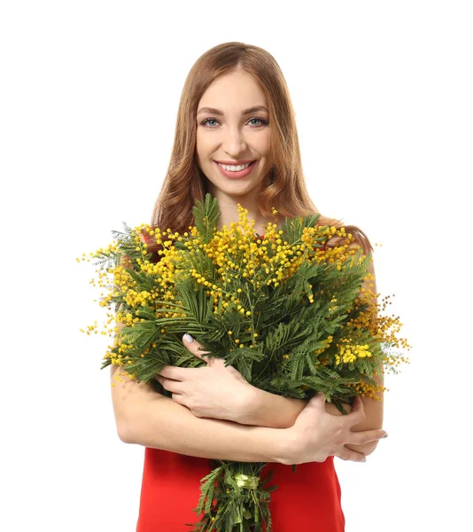 Beautiful young woman with bouquet of mimosa flowers on white background