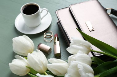 Güzel lale, kadın aksesuarları ve kahve fincan renk ahşap arka plan ile kompozisyon