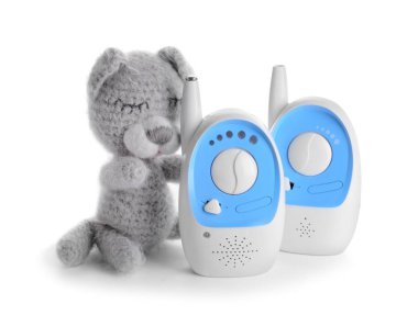 Modern baby monitors with toy on white background clipart