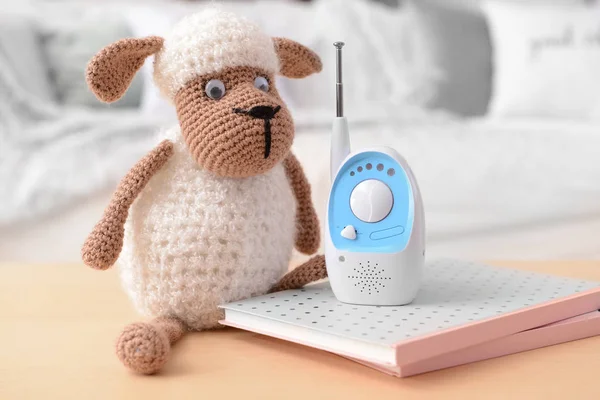 Modern baby monitor with toy on table in room — Stock Photo, Image