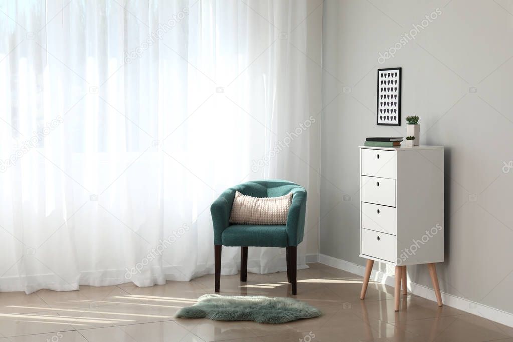 Light curtains with stylish furniture in interior of room