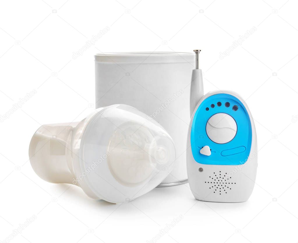 Modern baby monitor with milk formula on white background