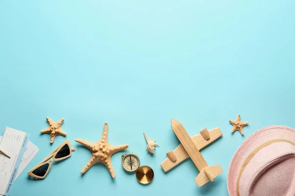 Toy airplane with compass, tickets, seashells and accessories on color background. Travel concept — Stock Photo, Image