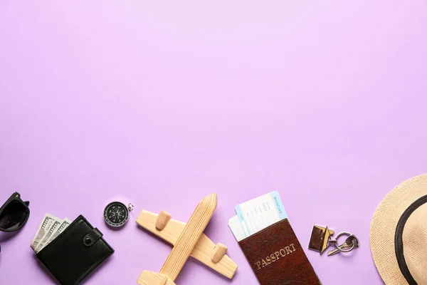 Toy airplane with passport, tickets, compass and wallet on color background. Travel concept — Stock Photo, Image