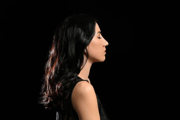 Portrait of beautiful woman on dark background — Stock Photo, Image