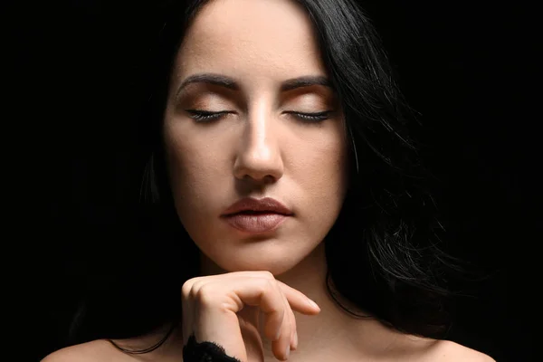 Portrait of beautiful woman on dark background — Stock Photo, Image