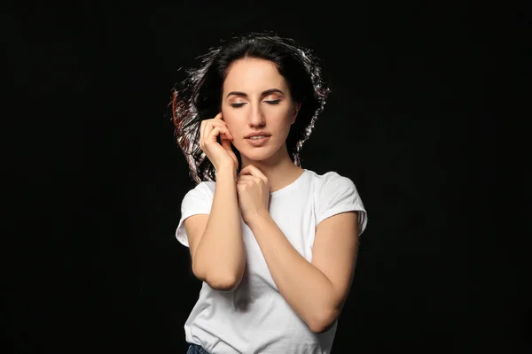 Portrait of beautiful woman on dark background — Stock Photo, Image