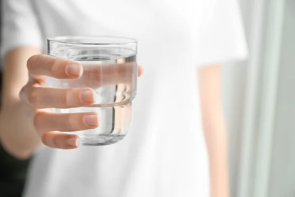 Woman with glass of water indoors, closeup — Stock Photo, Image