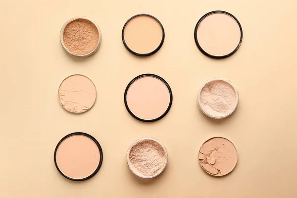 Different facial powder on color background