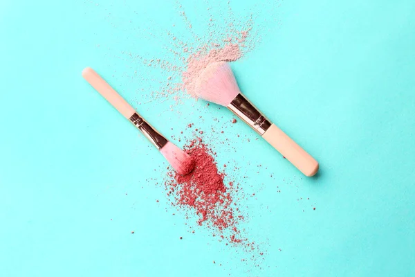 Facial powder and blusher with brushes on color background — Stock Photo, Image