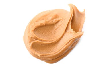 Beyaz arka planda lezzetli fıstık ezmesi.