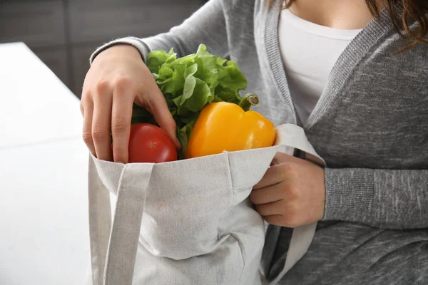 Fiatal nő az eco bag beltéri friss zöldségekkel — Stock Fotó