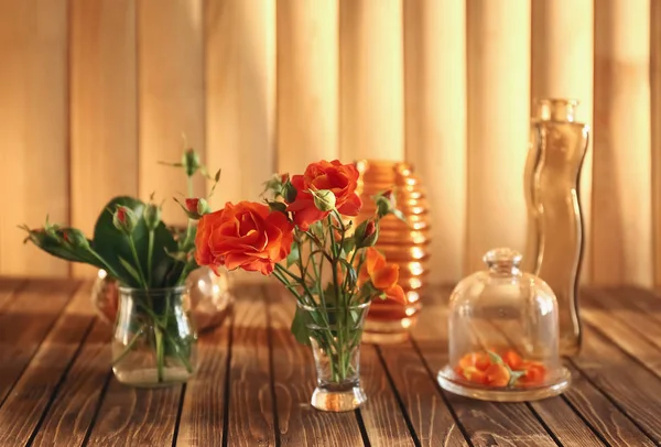 Beautiful flowers on wooden table — Stock Photo, Image