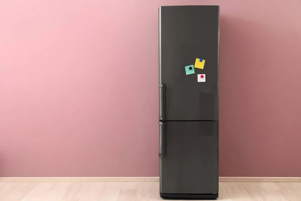 Big modern fridge near color wall — Stock Photo, Image