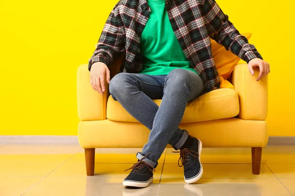 Homem elegante em sapatos sentados em poltrona perto da parede de cor — Fotografia de Stock