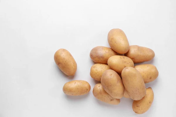 Raw potatoes on white background