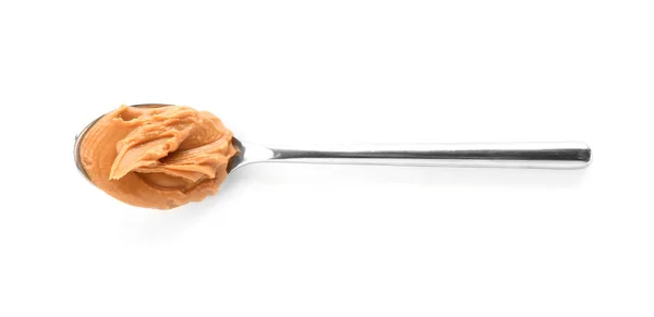 Spoon with tasty peanut butter on white background — Stock Photo, Image