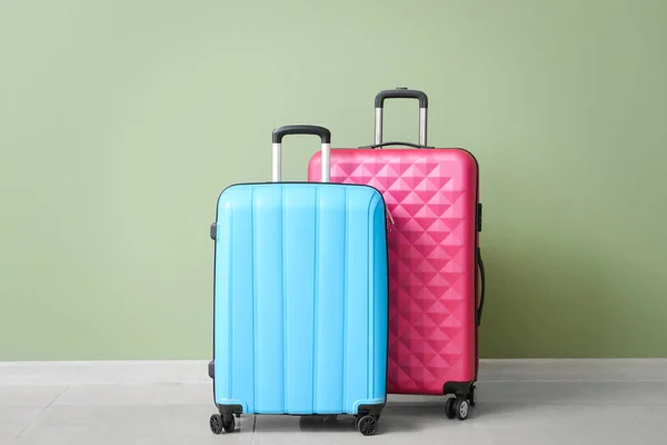 Packed suitcases near color wall — Stock Photo, Image