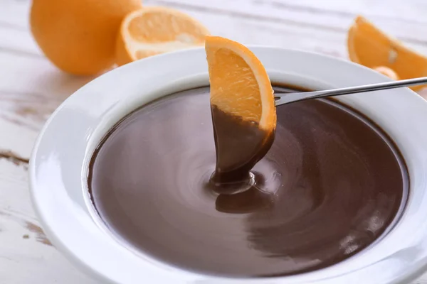 Masada çikolata fondü ile kase içine lezzetli turuncu daldırma — Stok fotoğraf