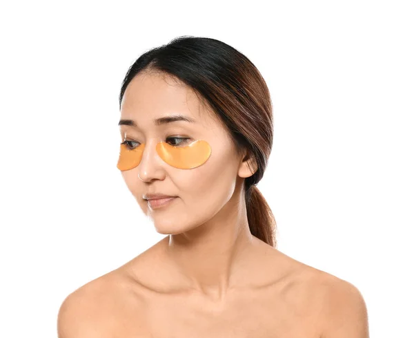 Asiatische Frau mit Augenflecken auf weißem Hintergrund — Stockfoto