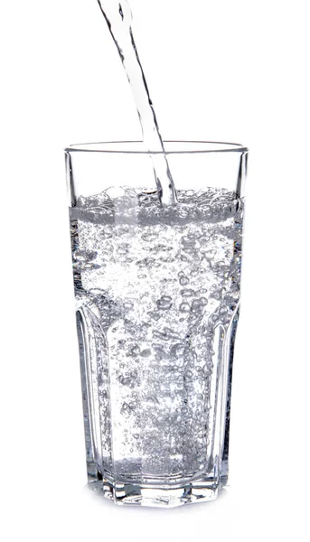 Pouring of water into glass on white background — Stock Photo, Image