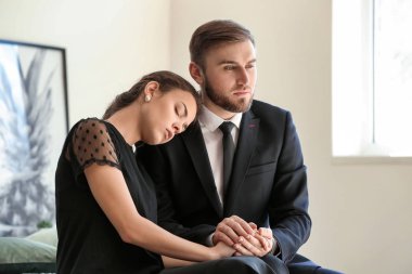 Couple pining after their relative after funeral clipart