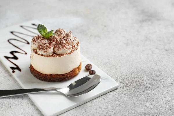 Tasty tiramisu on grey table — Stock Photo, Image