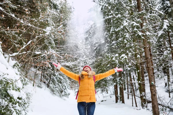 Beautiful woman playing with snow in winter forest — Stock Photo, Image