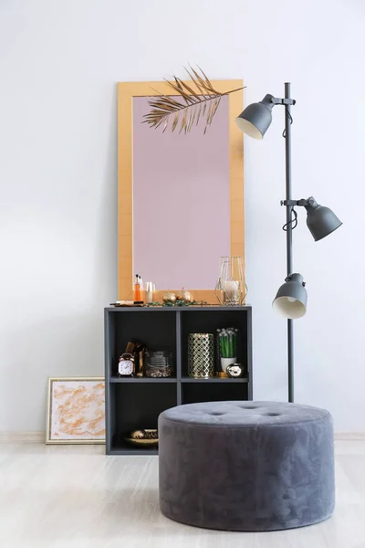 Golden mirror on shelves near light wall in room — Stock Photo, Image