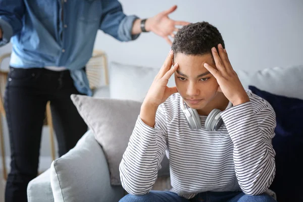 Sad African-American teenage boy having argument with his mother at home — Stock Photo, Image