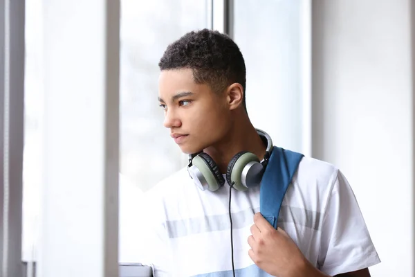 Portrait of African-American teenage boy near window — Stock Photo, Image