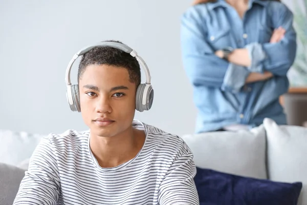 Sad African-American teenage boy having argument with his mother at home — Stock Photo, Image