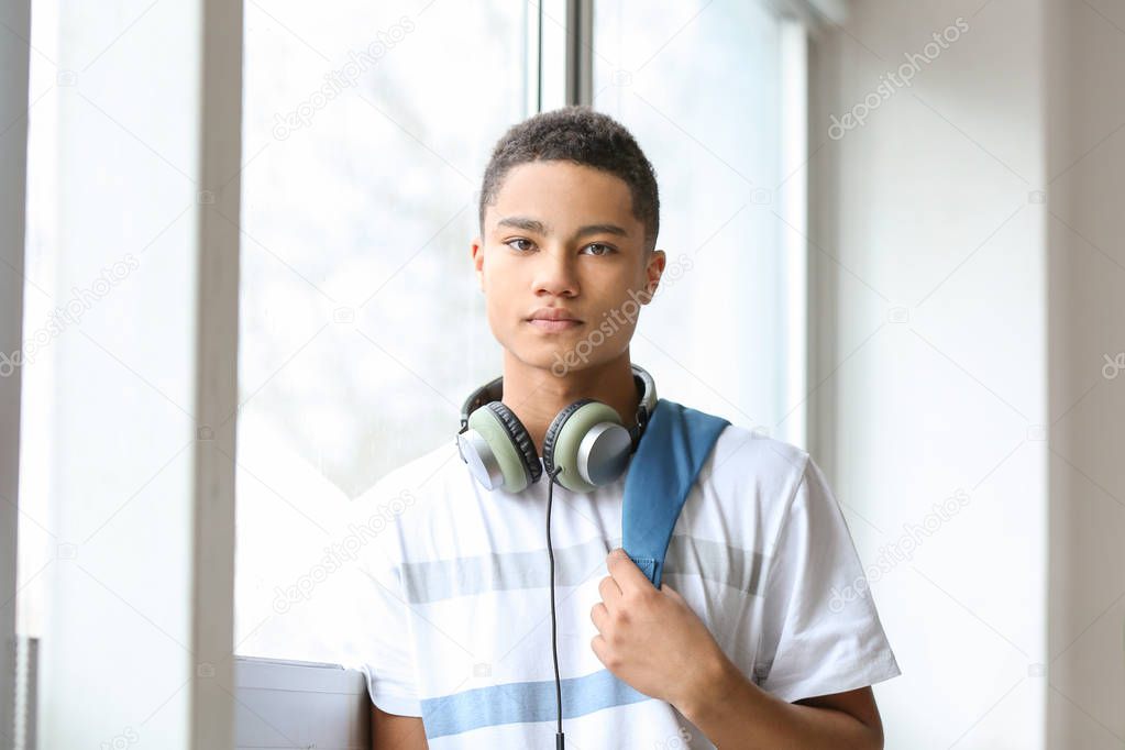 Portrait of African-American teenage boy near window