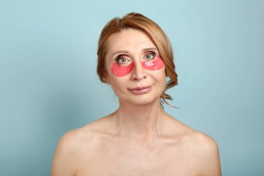 Renk arka planda göz altı yamaları ile Olgun kadın