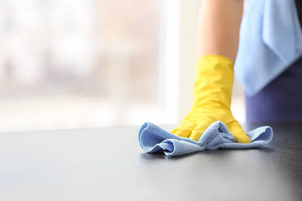 Male janitor cleaning table in office, closeup — Stock Photo, Image