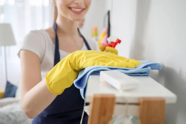 Female janitor cleaning shelf in room, closeup — Stock Photo, Image