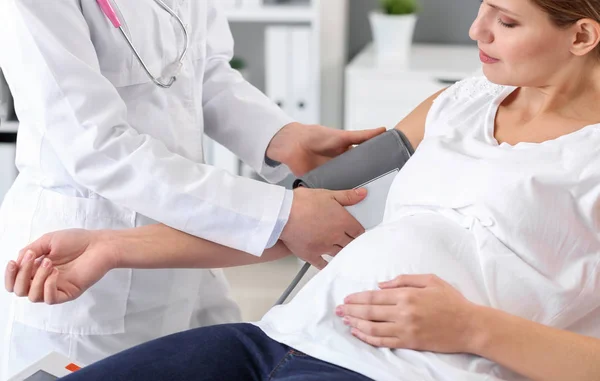 Ung gravid kvinna besöker sin gynekolog i kliniken — Stockfoto