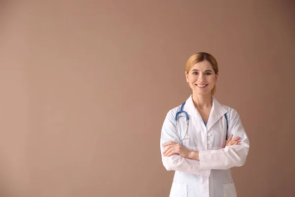 Portrait of beautiful gynecologist on color background — Stock Photo, Image