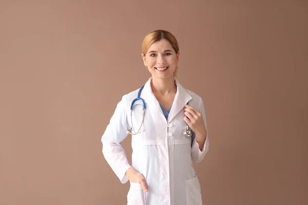 Portrait of beautiful gynecologist on color background — Stock Photo, Image