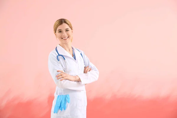 Portrait of beautiful gynecologist on color background — Stock Photo, Image